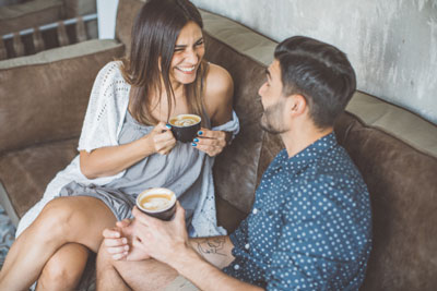 Need A Tinder Alternative? These 7 Dating Apps Are Better Than Tinder! 1 Man and woman enjoying cups of coffee on a casual date