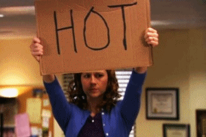 woman holding up a sign that says HOT