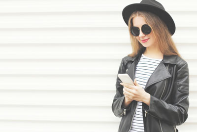 Tinder Plus, Gold or Platinum? Feature & 2025 Cost Comparison! 1 Trendy woman in leather jacket and hat checking out Tinder