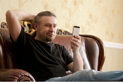 A Step-By-Step Guide To Delete Tinder & Start Over (& When You Shouldn't) 1 Man looking puzzled at his cell phone