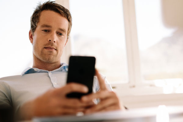 Man looking at The League's waitlist ranking on mobile