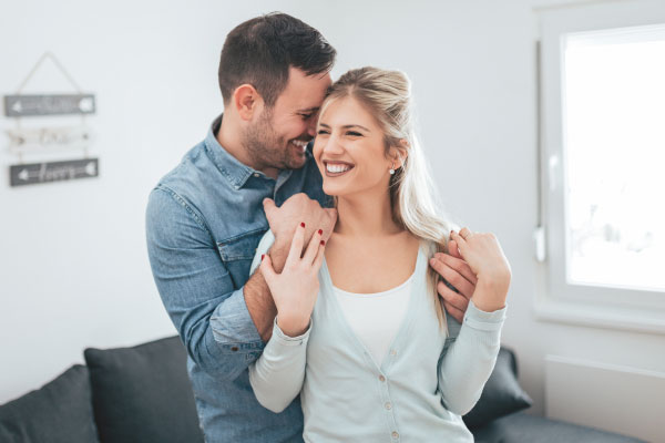 happy couple hugging and smiling